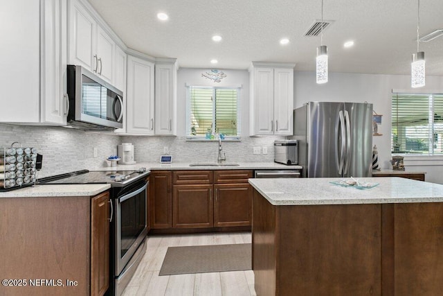 8211 Colee Cove Branch Rd Unit G, Saint Augustine, FL 32092 - kitchen featuring appliances with stainless steel finishes, a sink, healthy amount of natural light, white cabinetry, and recessed lighting