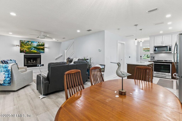 8211 Colee Cove Branch Rd Unit G, Saint Augustine, FL 32092 - dining area featuring ceiling fan, recessed lighting, stairway, baseboards, and light wood-style flooring
