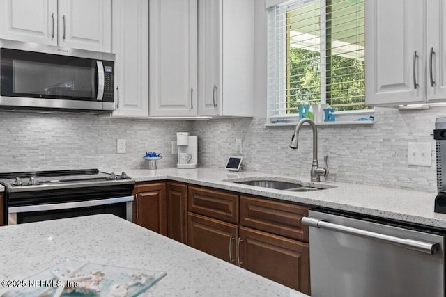 8211 Colee Cove Branch Rd Unit G, Saint Augustine, FL 32092 - kitchen with appliances with stainless steel finishes, white cabinetry, and a sink