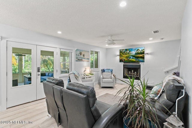 8211 Colee Cove Branch Rd Unit G, Saint Augustine, FL 32092 - living room featuring french doors, light wood-type flooring, a textured ceiling, ceiling fan, and recessed lighting