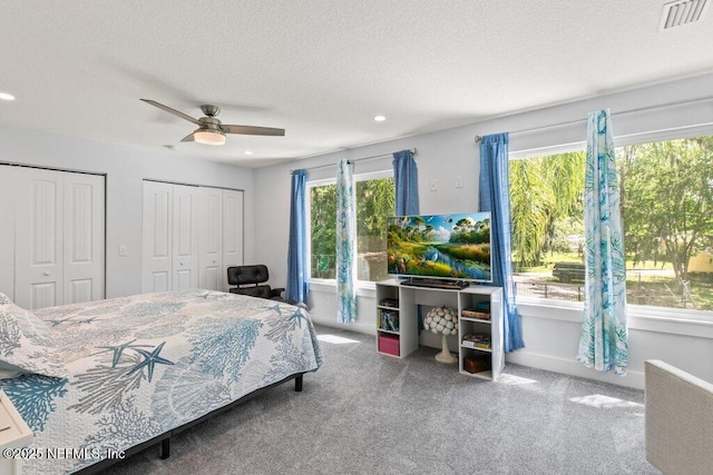 8211 Colee Cove Branch Rd Unit G, Saint Augustine, FL 32092 - carpeted bedroom with multiple closets, recessed lighting, ceiling fan, baseboards, and a textured ceiling