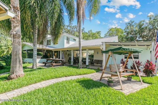 8211 Colee Cove Branch Rd Unit G, Saint Augustine, FL 32092 - back of house with metal roof, a patio area, and a yard