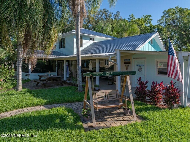 8211 Colee Cove Branch Rd Unit G, Saint Augustine, FL 32092 - view of front of house with metal roof, a front lawn, and a patio area