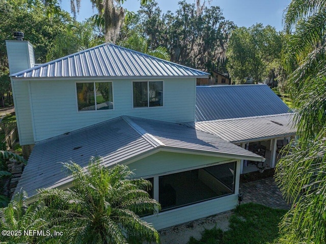 8211 Colee Cove Branch Rd Unit G, Saint Augustine, FL 32092 - back of property with metal roof, a chimney, and a sunroom