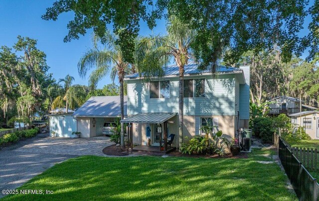 8211 Colee Cove Branch Rd Unit G, Saint Augustine, FL 32092 - view of front of house featuring driveway, a chimney, metal roof, and covered porch
