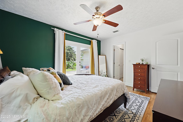 5327 Attleboro St, Jacksonville, FL 32205 - bedroom featuring access to exterior, wood finished floors, a textured ceiling, and ceiling fan