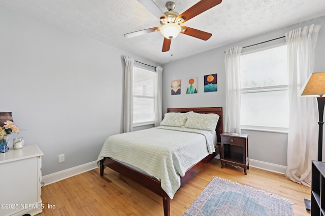 5327 Attleboro St, Jacksonville, FL 32205 - bedroom with baseboards, light wood-type flooring, ceiling fan, and a textured ceiling