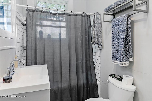 full bathroom with toilet, vanity, and a shower with shower curtain