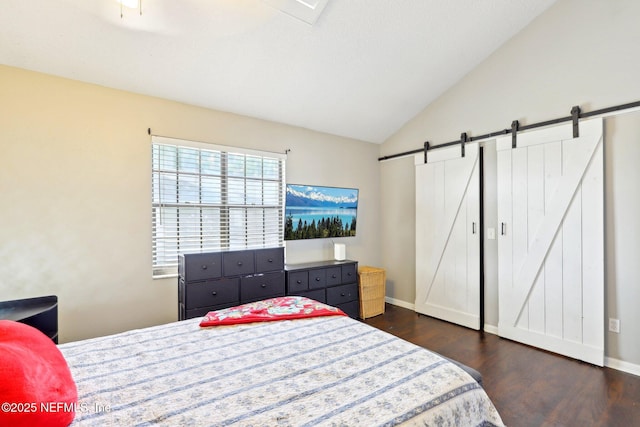 1101 Kettering Way, Orange Park, FL 32073 - bedroom featuring a barn door, dark wood-style flooring, vaulted ceiling, and baseboards