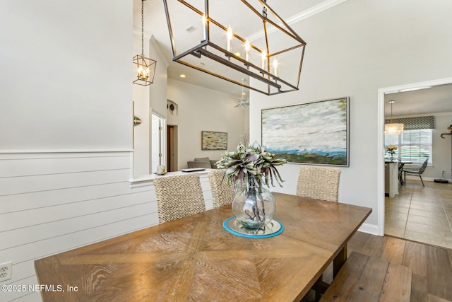 2738 Sea Grove Ln, Fernandina Beach, FL 32034 - dining space featuring a chandelier, a high ceiling, wood finished floors, and ornamental molding