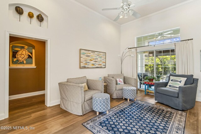 2738 Sea Grove Ln, Fernandina Beach, FL 32034 - living area featuring a high ceiling, crown molding, wood finished floors, a ceiling fan, and baseboards