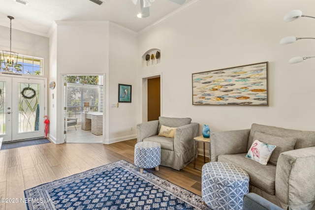 2738 Sea Grove Ln, Fernandina Beach, FL 32034 - living room featuring ornamental molding, wood finished floors, a chandelier, baseboards, and a ceiling fan