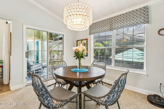 2738 Sea Grove Ln, Fernandina Beach, FL 32034 - dining room featuring crown molding, a chandelier, baseboards, and light tile patterned floors