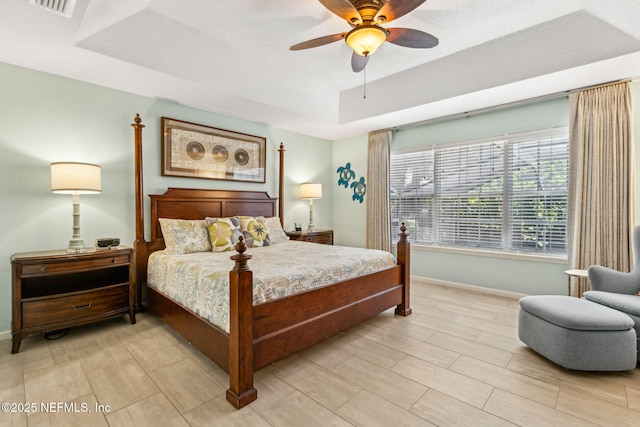2738 Sea Grove Ln, Fernandina Beach, FL 32034 - bedroom featuring a tray ceiling, baseboards, and ceiling fan