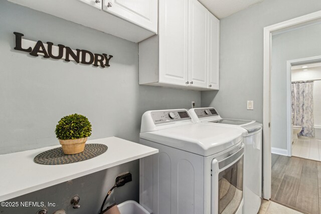 2738 Sea Grove Ln, Fernandina Beach, FL 32034 - washroom with cabinet space, independent washer and dryer, and light tile patterned floors