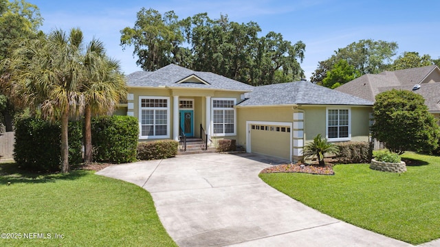 2738 Sea Grove Ln, Fernandina Beach, FL 32034 - ranch-style home featuring stucco siding, an attached garage, concrete driveway, a front lawn, and a shingled roof