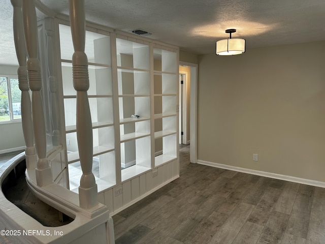 234 Canis St W, Orange Park, FL 32073 - spare room featuring baseboards, dark wood-style floors, and a textured ceiling