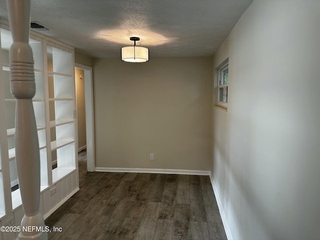 234 Canis St W, Orange Park, FL 32073 - unfurnished room with dark wood-type flooring, a textured ceiling, and baseboards