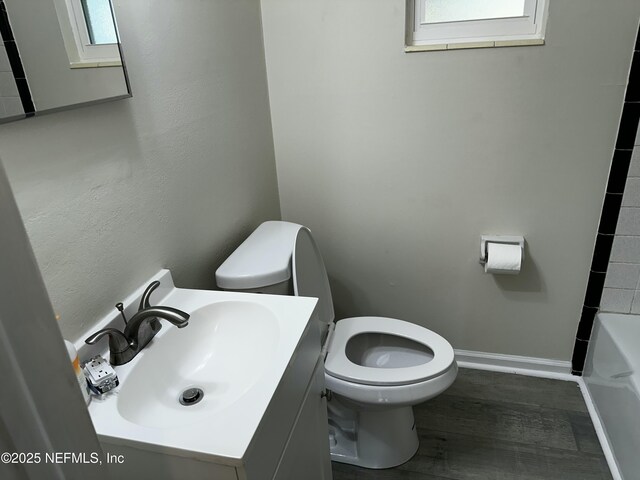 234 Canis St W, Orange Park, FL 32073 - full bath with toilet, vanity, wood finished floors, and baseboards