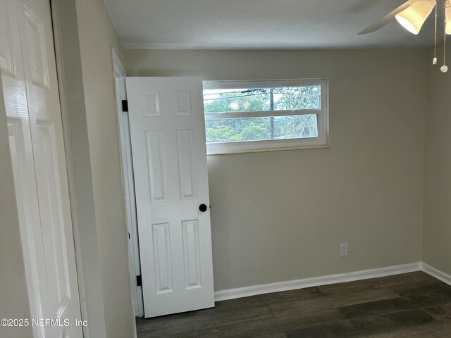 234 Canis St W, Orange Park, FL 32073 - empty room featuring dark wood-style floors, baseboards, and a ceiling fan