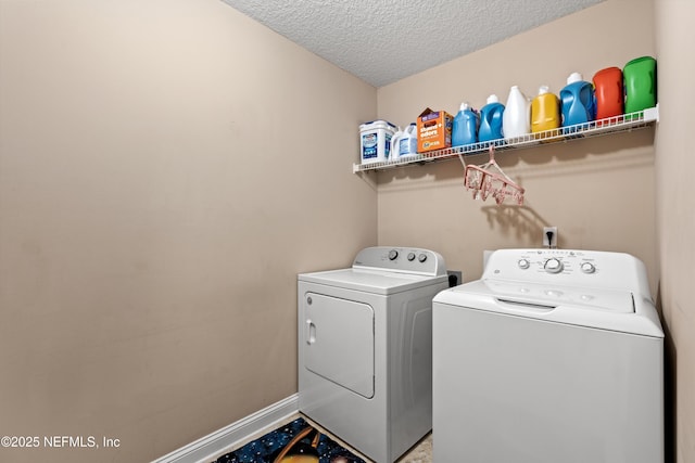 129 Lake Run Blvd, Jacksonville, FL 32218 - laundry area with washer and clothes dryer, a textured ceiling, and baseboards