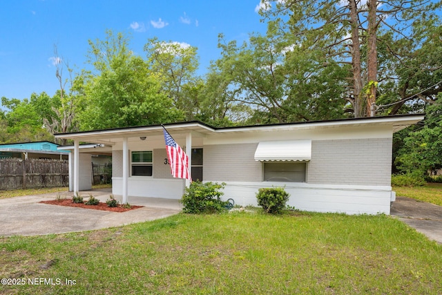 3930 Cottonwood Ln, Jacksonville, FL 32207 - mid-century modern home with brick siding, a carport, and driveway