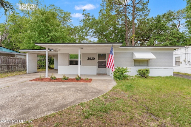 3930 Cottonwood Ln, Jacksonville, FL 32207 - mid-century modern home featuring brick siding, concrete driveway, and an attached carport
