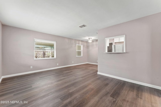 3930 Cottonwood Ln, Jacksonville, FL 32207 - unfurnished room with baseboards, dark wood-style flooring, and a ceiling fan