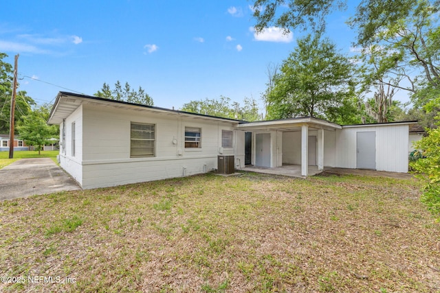 3930 Cottonwood Ln, Jacksonville, FL 32207 - back of house with a lawn and central AC unit