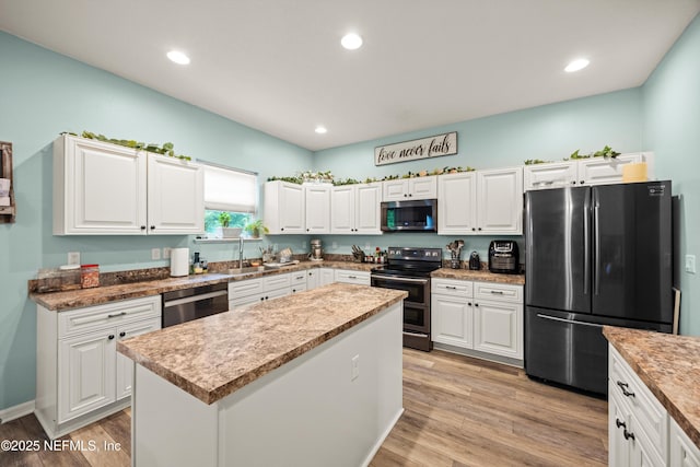 97054 Huntington Ct, Yulee, FL 32097 - kitchen with appliances with stainless steel finishes, a sink, white cabinetry, light wood-style floors, and recessed lighting