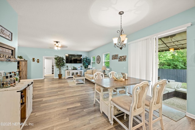 97054 Huntington Ct, Yulee, FL 32097 - dining space with light wood-style flooring, a chandelier, baseboards, and a ceiling fan