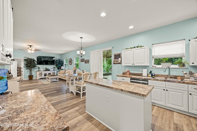 97054 Huntington Ct, Yulee, FL 32097 - kitchen featuring a sink, white cabinets, a center island, dishwasher, and open floor plan
