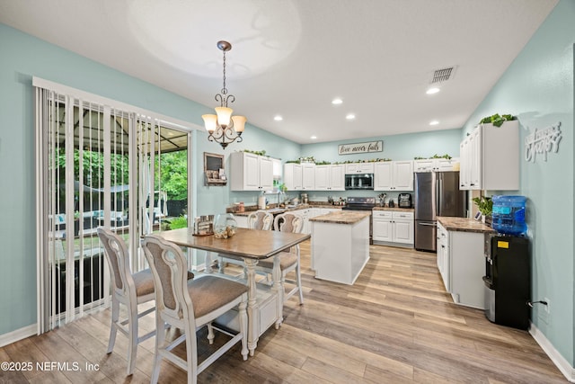 97054 Huntington Ct, Yulee, FL 32097 - dining space featuring light wood-style floors, recessed lighting, a chandelier, and baseboards