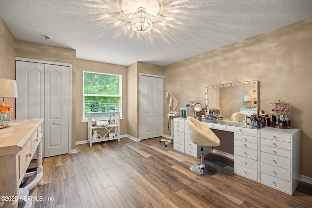 97054 Huntington Ct, Yulee, FL 32097 - office space featuring a textured ceiling, wood finished floors, baseboards, and a chandelier
