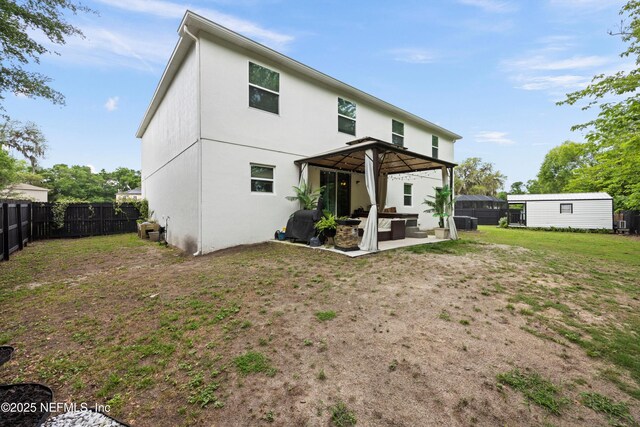 97054 Huntington Ct, Yulee, FL 32097 - back of property featuring outdoor lounge area, a gazebo, a patio area, stucco siding, and central air condition unit