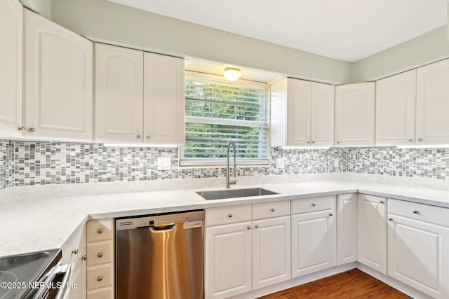 5201 Atlantic Blvd Unit 142, Jacksonville, FL 32207 - kitchen featuring appliances with stainless steel finishes, a sink, white cabinets, decorative backsplash, and light countertops