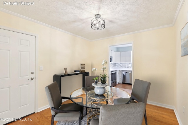 5201 Atlantic Blvd Unit 142, Jacksonville, FL 32207 - dining room with crown molding, light wood-type flooring, a textured ceiling, and baseboards