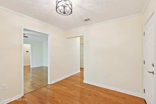 5201 Atlantic Blvd Unit 142, Jacksonville, FL 32207 - unfurnished bedroom featuring wood finished floors, crown molding, a textured ceiling, a chandelier, and baseboards