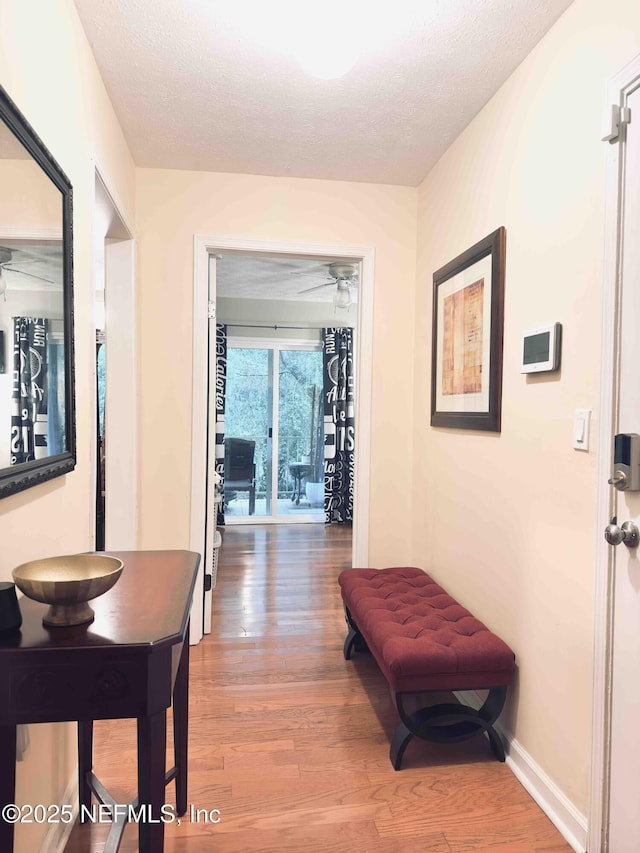5201 Atlantic Blvd Unit 142, Jacksonville, FL 32207 - corridor featuring wood finished floors, a textured ceiling, and baseboards