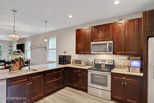 616 Osman Rd, Jacksonville, FL 32225 - kitchen featuring appliances with stainless steel finishes, a sink, healthy amount of natural light, light wood-style flooring, and recessed lighting