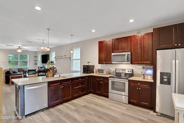616 Osman Rd, Jacksonville, FL 32225 - kitchen featuring stainless steel appliances, a peninsula, a sink, light wood-style flooring, and open floor plan