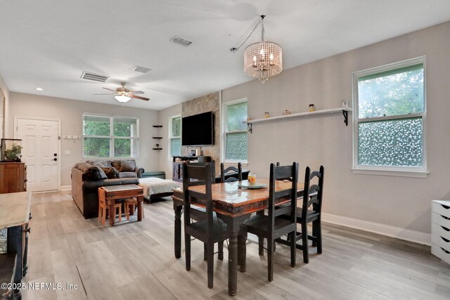 616 Osman Rd, Jacksonville, FL 32225 - dining space with light wood-style floors, a ceiling fan, a chandelier, and baseboards