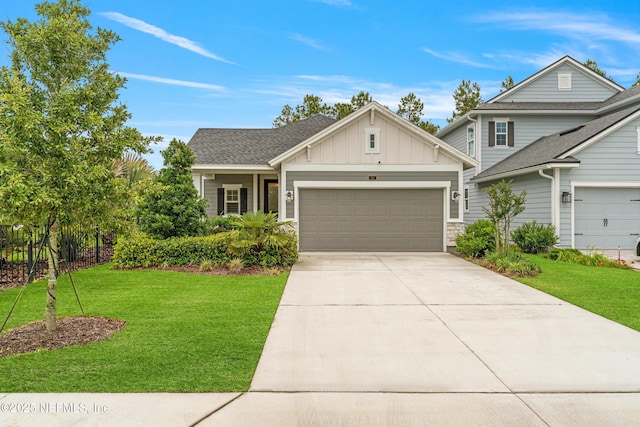 166 Spinner Dr, Ponte Vedra, FL 32081 - view of front of home featuring board and batten siding, a garage, a front lawn, and concrete driveway