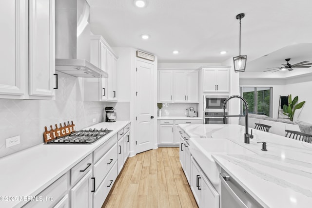 166 Spinner Dr, Ponte Vedra, FL 32081 - kitchen with wall chimney range hood, gas stovetop, oven, built in microwave, and white cabinetry