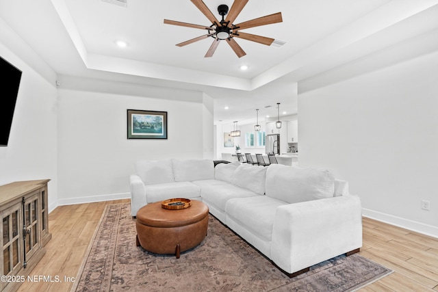 166 Spinner Dr, Ponte Vedra, FL 32081 - living area with a ceiling fan, light wood-style floors, baseboards, recessed lighting, and a raised ceiling
