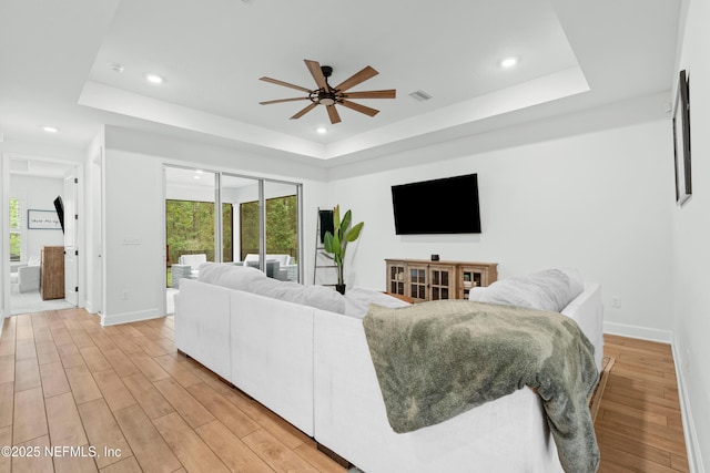 166 Spinner Dr, Ponte Vedra, FL 32081 - living room with a tray ceiling, a ceiling fan, light wood finished floors, recessed lighting, and plenty of natural light