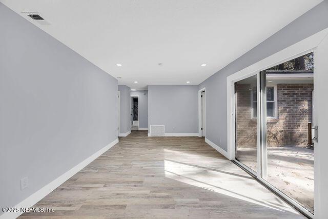 empty room with baseboards, light wood-style flooring, and recessed lighting