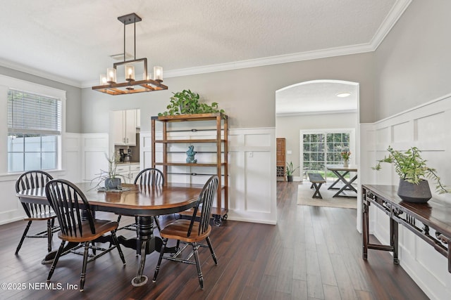 1821 W Windy Way, Saint Johns, FL 32259 - dining area featuring a decorative wall, arched walkways, ornamental molding, dark wood-style floors, and wainscoting