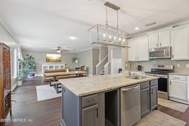 1821 W Windy Way, Saint Johns, FL 32259 - kitchen with a sink, stainless steel appliances, crown molding, decorative backsplash, and white cabinetry