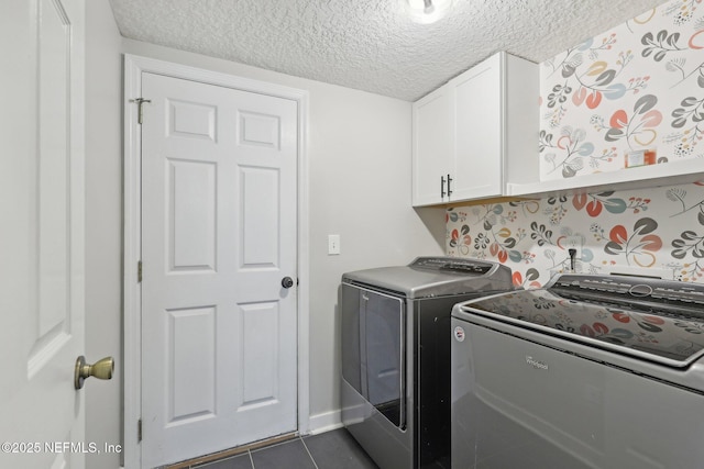 1821 W Windy Way, Saint Johns, FL 32259 - clothes washing area featuring washer and dryer, cabinet space, a textured ceiling, dark tile patterned floors, and baseboards